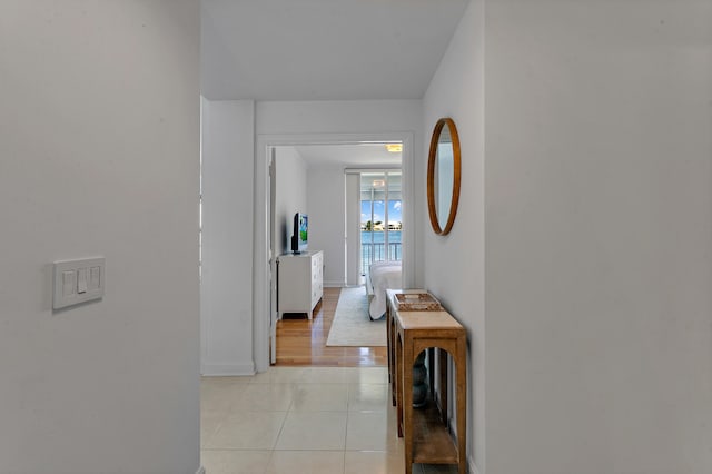 hallway with light hardwood / wood-style flooring