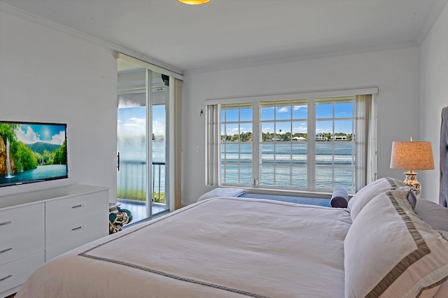 bedroom featuring ornamental molding, a water view, and access to outside