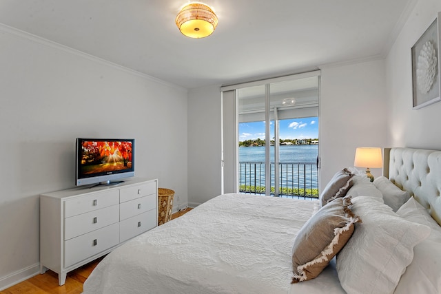 bedroom with ornamental molding, access to exterior, and light wood-type flooring