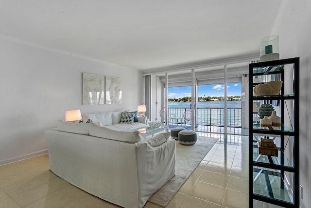 tiled living room with a water view, crown molding, and floor to ceiling windows