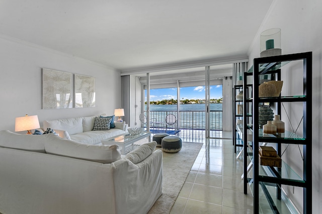 tiled living room featuring ornamental molding, expansive windows, and a water view