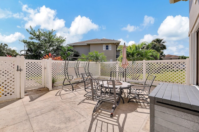 view of patio / terrace featuring outdoor dining space and fence