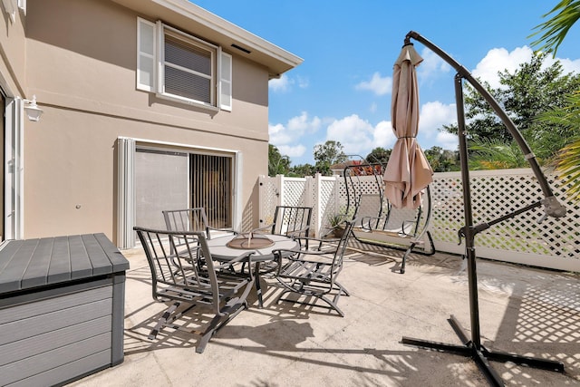 view of patio with fence and outdoor dining area