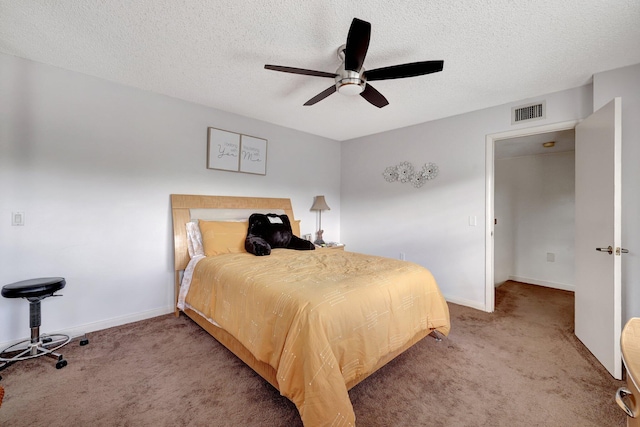 carpeted bedroom with visible vents, ceiling fan, a textured ceiling, and baseboards