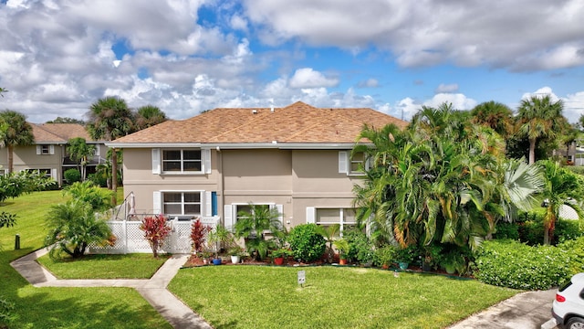 view of front of home with a front lawn and stucco siding