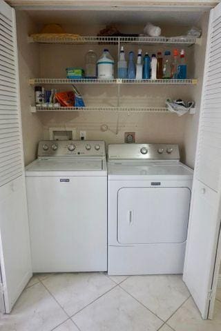 washroom with light tile patterned flooring and independent washer and dryer