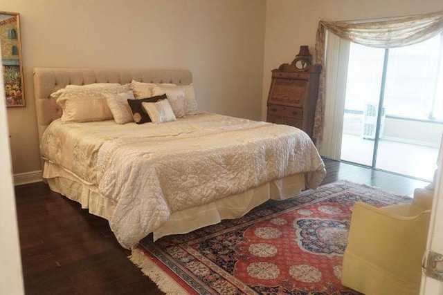 bedroom featuring dark hardwood / wood-style floors and access to exterior