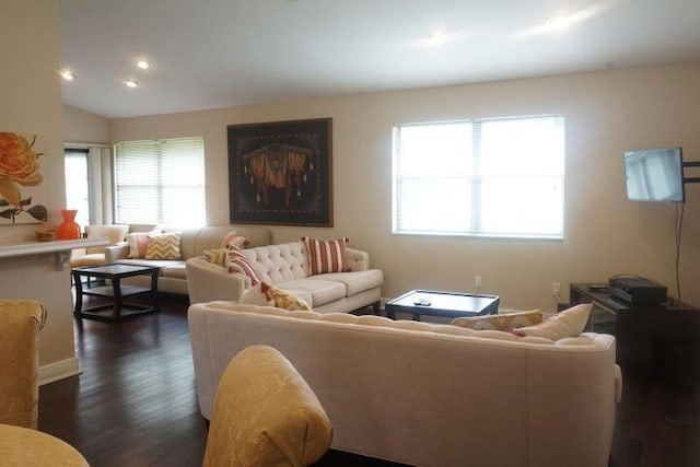 living room featuring plenty of natural light, dark wood-type flooring, and lofted ceiling