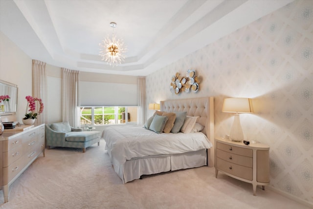 bedroom featuring a raised ceiling, an inviting chandelier, and light colored carpet