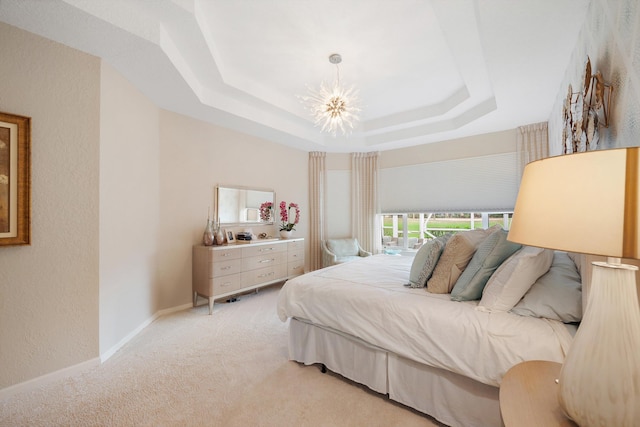 bedroom with light colored carpet, an inviting chandelier, and a raised ceiling