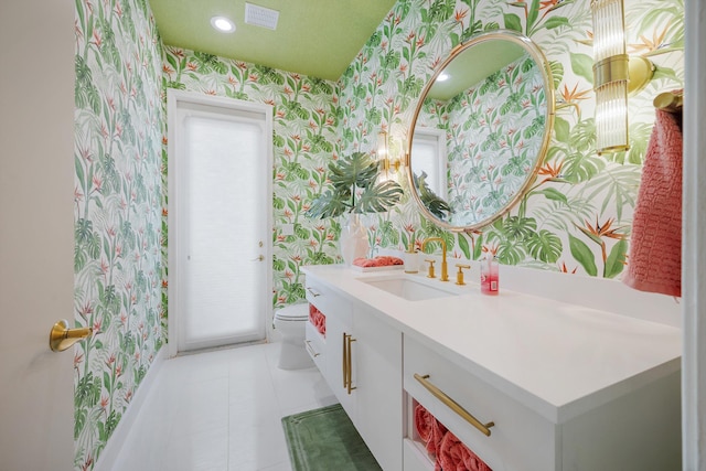 bathroom featuring toilet, vanity, and tile patterned floors