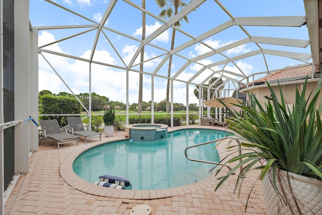 view of pool with a patio, an in ground hot tub, and glass enclosure