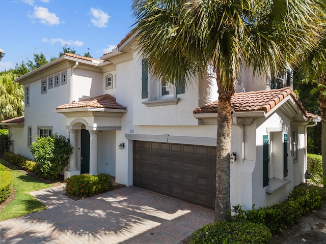 mediterranean / spanish-style house with a garage