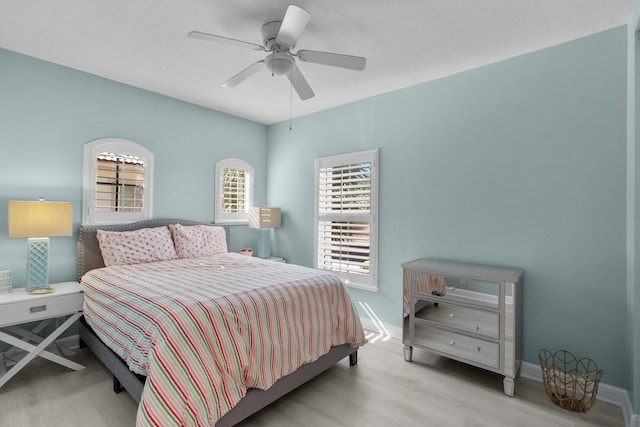 bedroom with ceiling fan and light hardwood / wood-style floors