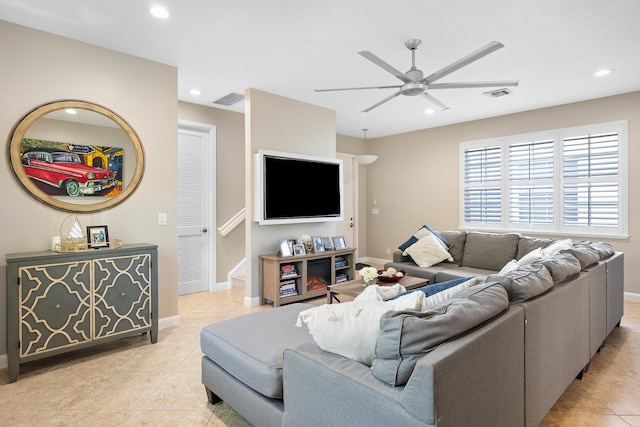 tiled living room with ceiling fan