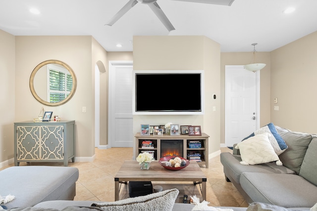 living room featuring light tile patterned flooring and ceiling fan