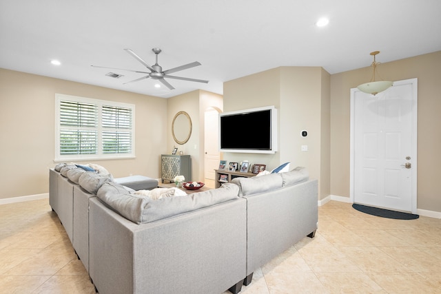 living room featuring light tile patterned floors and ceiling fan