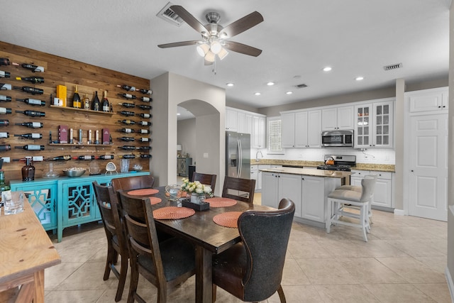 dining area featuring light tile patterned floors and ceiling fan