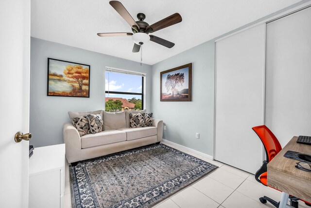 tiled office space featuring ceiling fan