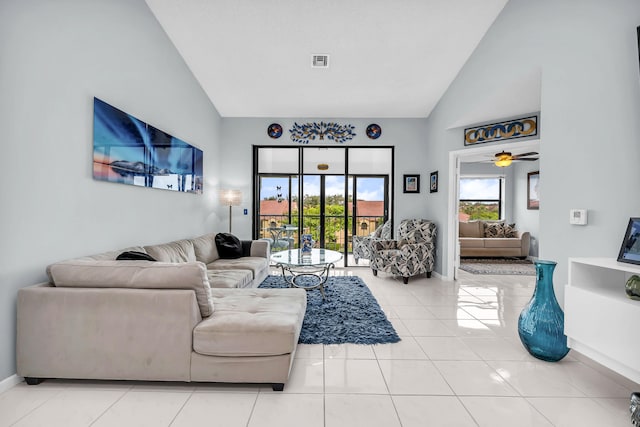 living room with ceiling fan, high vaulted ceiling, and light tile patterned floors