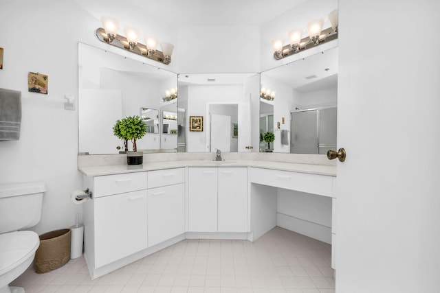 bathroom with vanity, toilet, and walk in shower