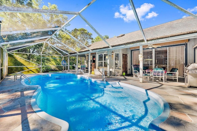 view of pool with a patio, ceiling fan, glass enclosure, and french doors