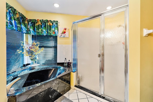 bathroom featuring tile patterned floors and shower with separate bathtub