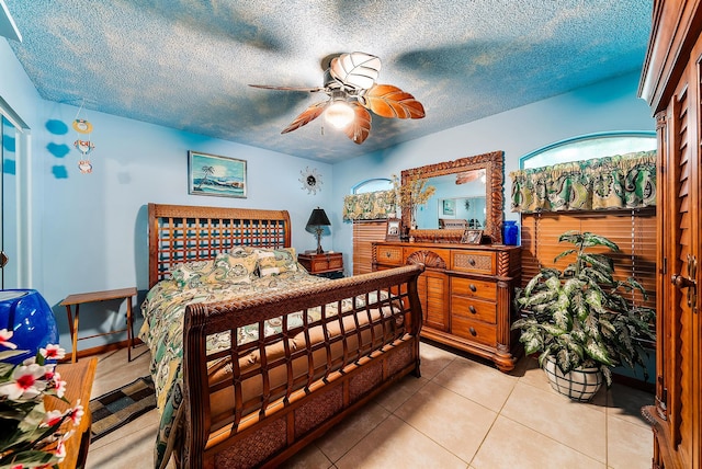 tiled bedroom featuring a textured ceiling and ceiling fan