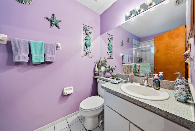 bathroom featuring vanity, toilet, a shower with shower door, and tile patterned flooring