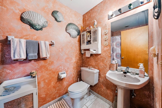 bathroom featuring toilet, curtained shower, and tile patterned floors