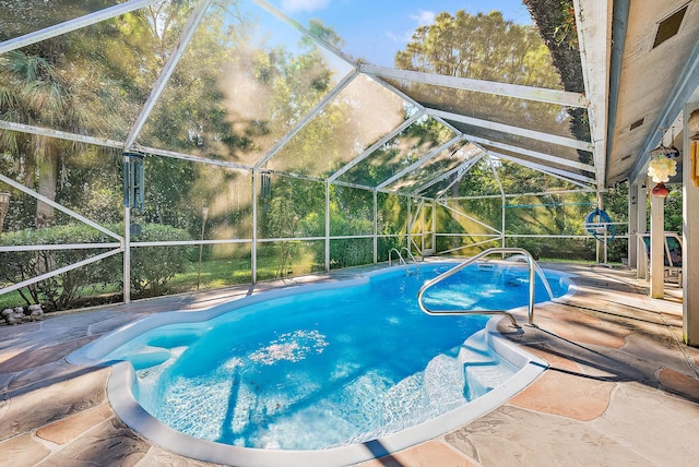 view of pool featuring a patio area and glass enclosure