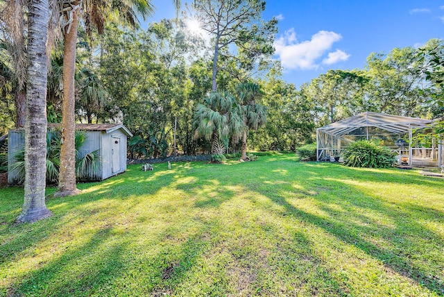 view of yard with a lanai and a shed