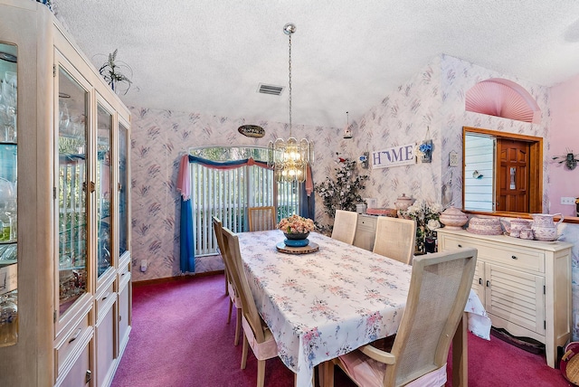 dining room with a chandelier, vaulted ceiling, a textured ceiling, and carpet flooring