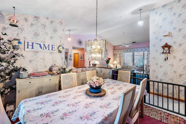 dining room with lofted ceiling, a textured ceiling, carpet flooring, and ceiling fan with notable chandelier