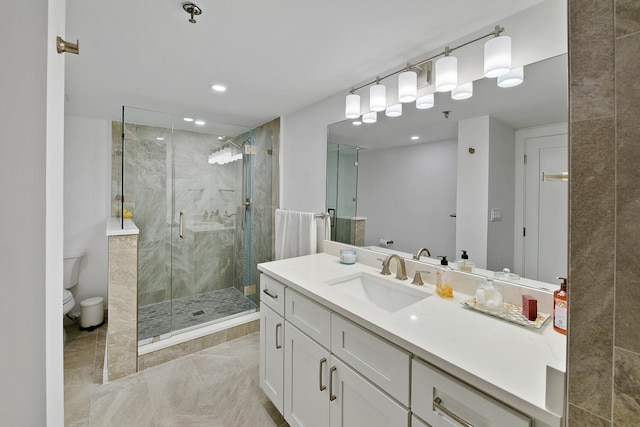 bathroom featuring vanity, toilet, and a shower with shower door