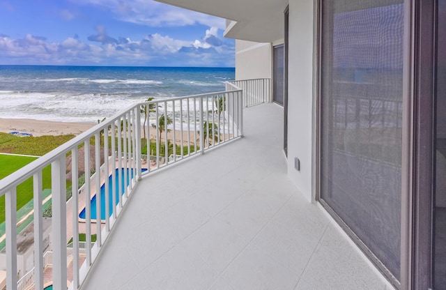 balcony with a view of the beach and a water view