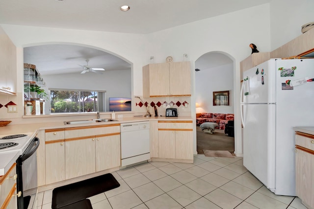 kitchen with lofted ceiling, sink, ceiling fan, white appliances, and tasteful backsplash