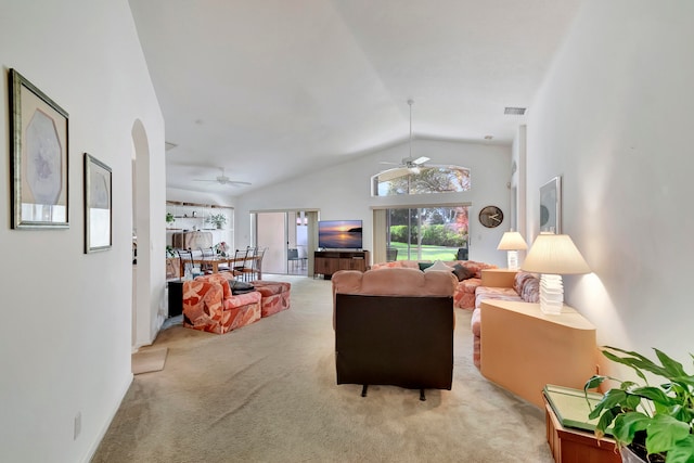 living room featuring light carpet, ceiling fan, and vaulted ceiling