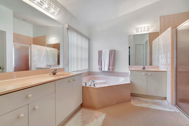 bathroom featuring vanity, independent shower and bath, and tile patterned flooring