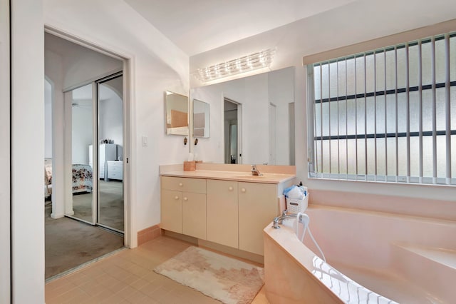 bathroom featuring vanity, a tub, and tile patterned floors