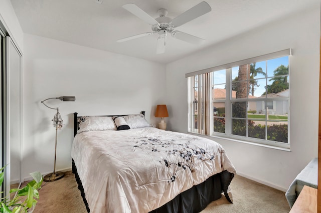 carpeted bedroom featuring a closet and ceiling fan