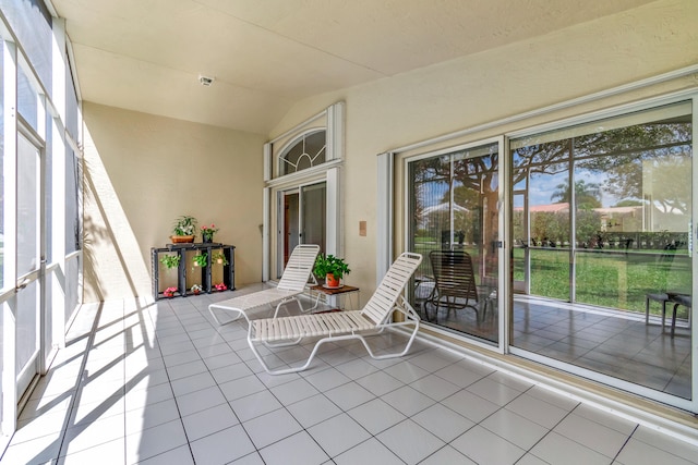 unfurnished sunroom featuring vaulted ceiling