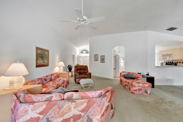 carpeted living room with lofted ceiling and ceiling fan