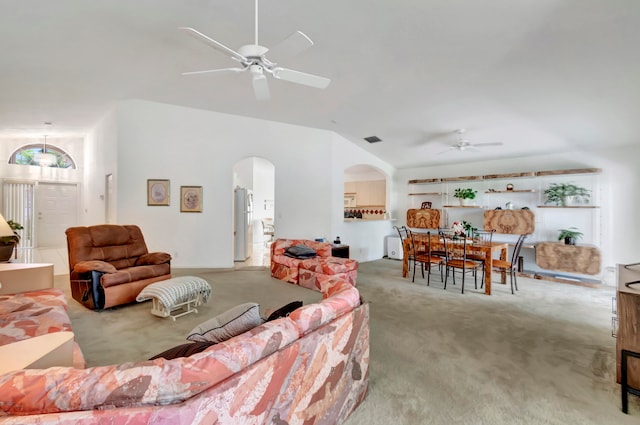 living room featuring light carpet, vaulted ceiling, and ceiling fan