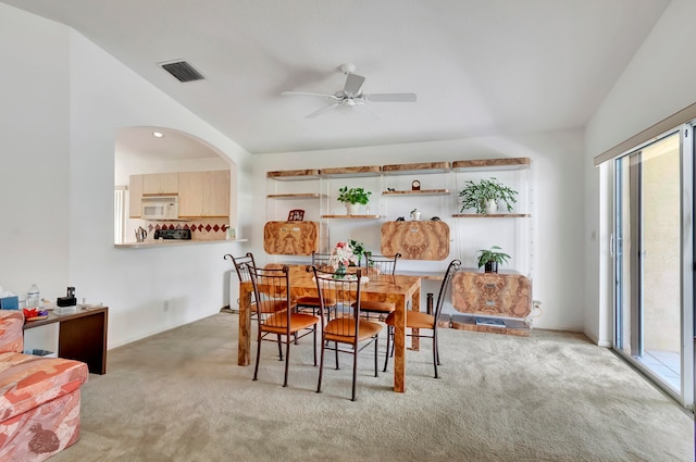 carpeted dining room featuring a wealth of natural light and ceiling fan