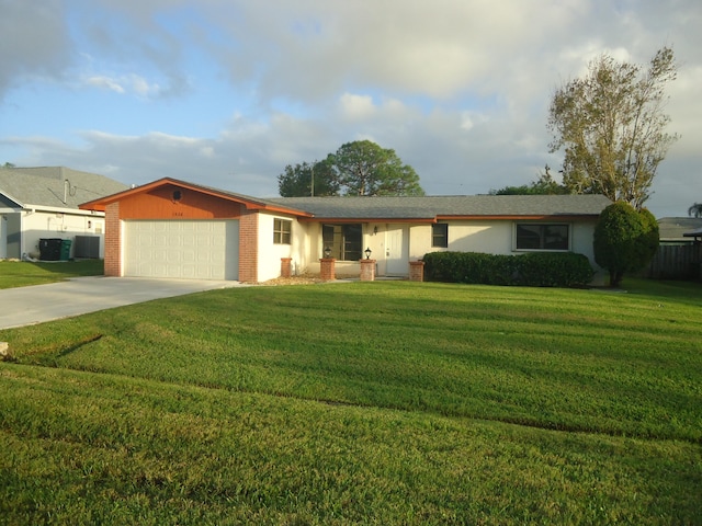 single story home with a garage and a front lawn