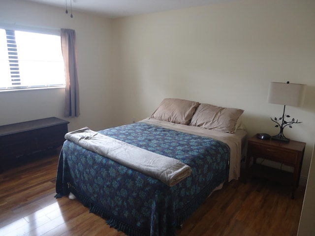 bedroom featuring dark hardwood / wood-style flooring