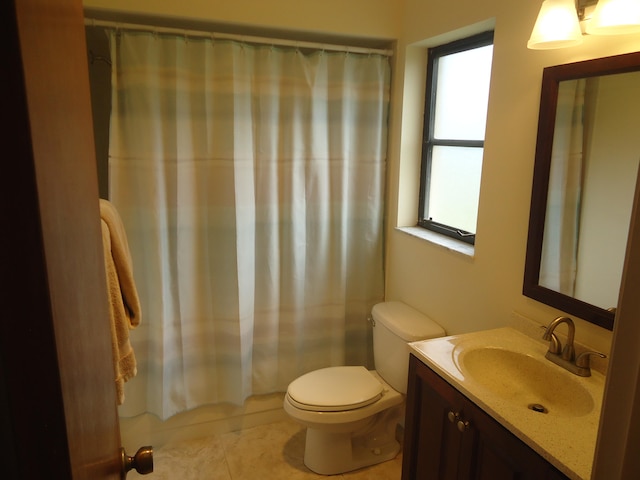 full bathroom with vanity, a wealth of natural light, tile patterned floors, and toilet