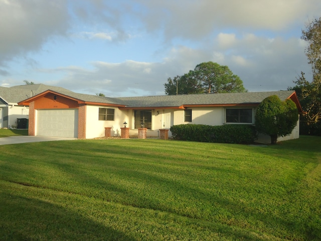 ranch-style house featuring a garage and a front yard