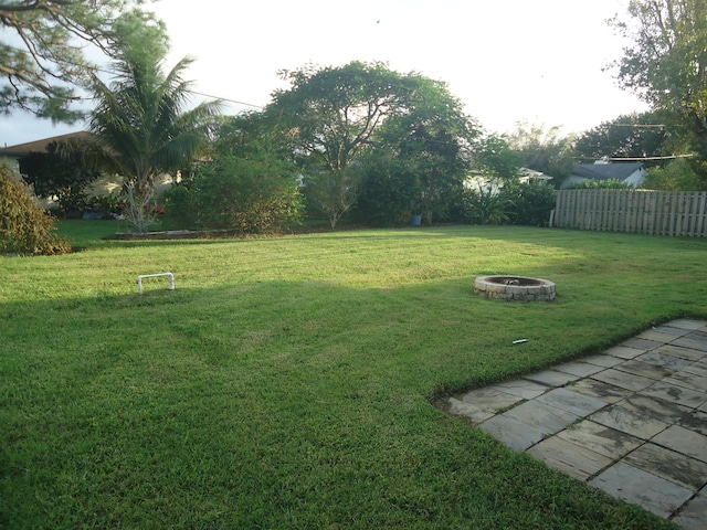 view of yard with a fire pit